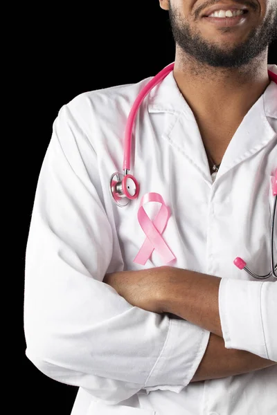 dark skin doctor with pink stethoscope and pink awareness breast cancer ribbon, on a black background.