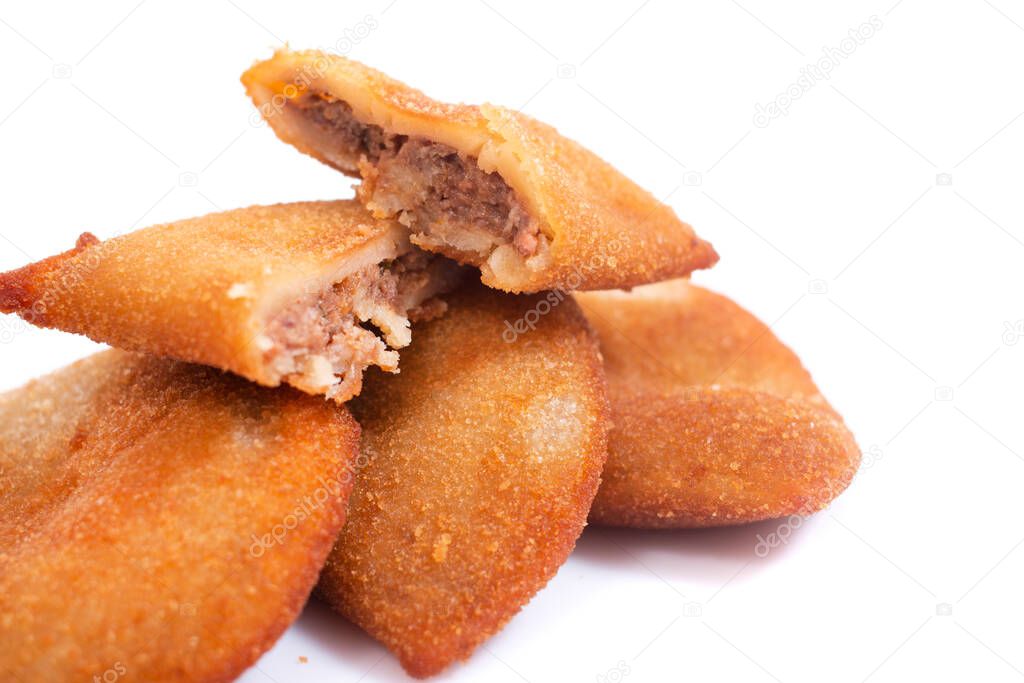 Typical Portuguese deep fried rissol appetizers, generally with meat or shrimp isolated on a white background.