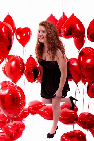 Heureuse jeune fille entre les ballons rouges — Photo