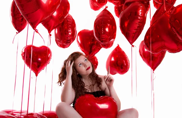 Happy young girl between red balloons — Stock Photo, Image