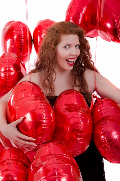 Heureuse jeune fille entre les ballons rouges — Photo