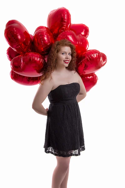 Gelukkig jong meisje tussen rode ballonnen — Stockfoto