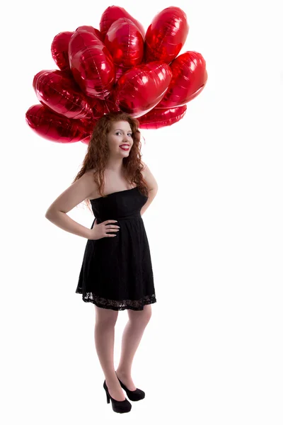 Heureuse jeune fille entre les ballons rouges — Photo