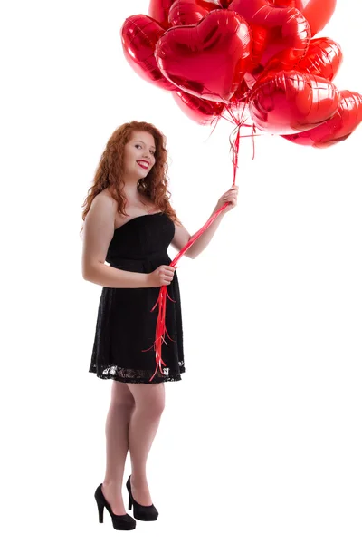 Gelukkig jong meisje tussen rode ballonnen — Stockfoto