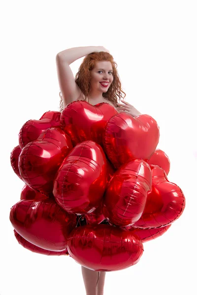 Feliz chica joven con muchos globos rojos — Foto de Stock