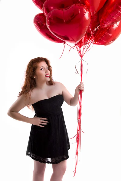 Gelukkig jong meisje met veel rood ballonnen — Stockfoto