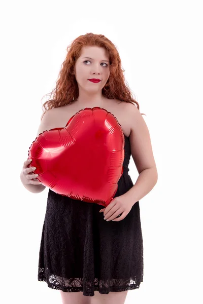 Happy young girl holding a red balloon — Stock Photo, Image