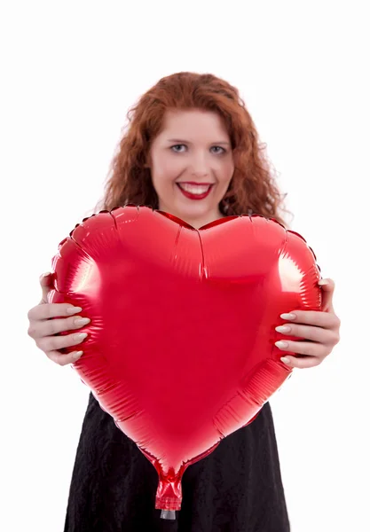Happy young girl holding a red balloon — Stock Photo, Image