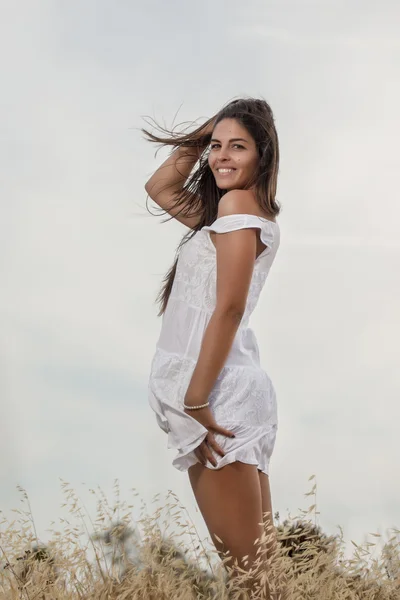 Beautiful woman on a white dress — Stock Photo, Image