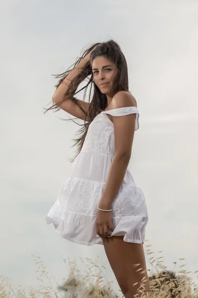 Beautiful woman on a white dress — Stock Photo, Image