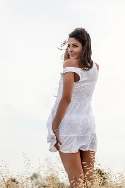 Beautiful woman on a white dress — Stock Photo, Image