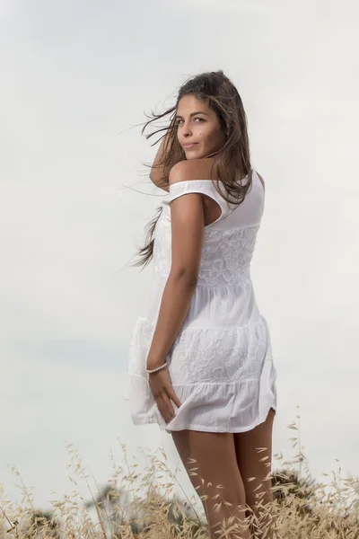 Beautiful woman on a white dress — Stock Photo, Image