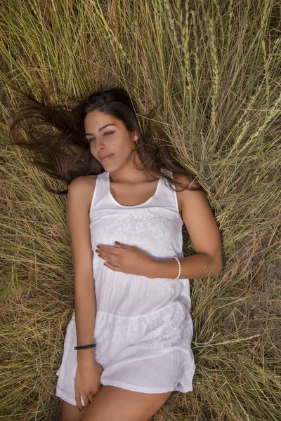 Beautiful woman on a white dress — Stock Photo, Image