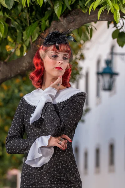 Young redhead girl on a retro vintage dress — Stock Photo, Image