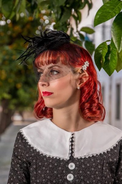 Young redhead girl on a retro vintage dress — Stock Photo, Image