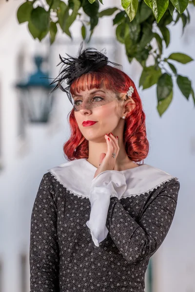 Young redhead girl on a retro vintage dress — Stock Photo, Image