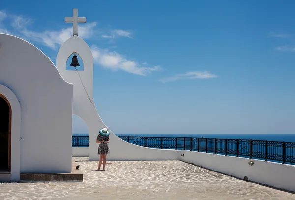 A menina de chapéu no pano de fundo da Igreja Ortodoxa Grega — Fotografia de Stock