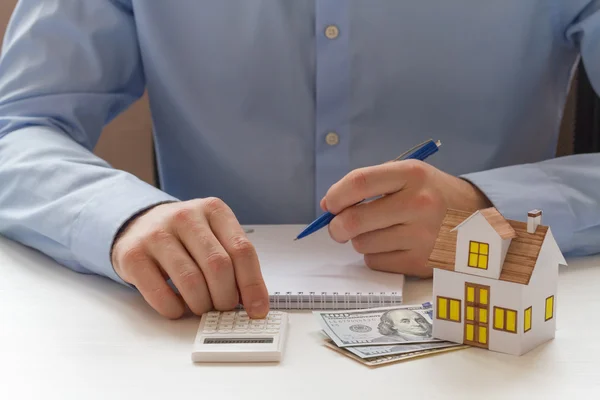 Businessmen counting on calculator — Stock Photo, Image