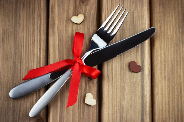 Silver fork and knife decorated red bow Royalty Free Stock Images