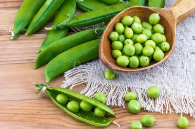 Fresh green peas and spoon clipart