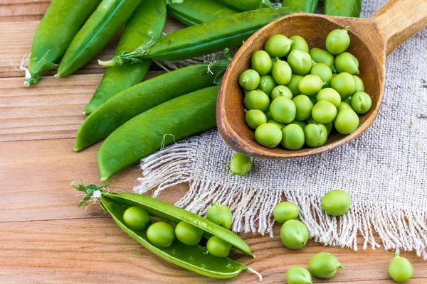 Guisantes verdes frescos y cuchara —  Fotos de Stock