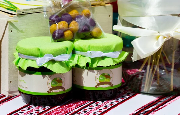 Jars of kiwi jam with color candys — Stock Photo, Image