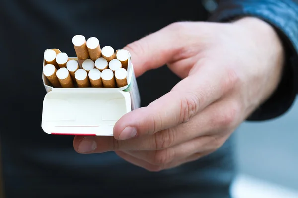 Male hand take pack of cigarettes — Stock Photo, Image