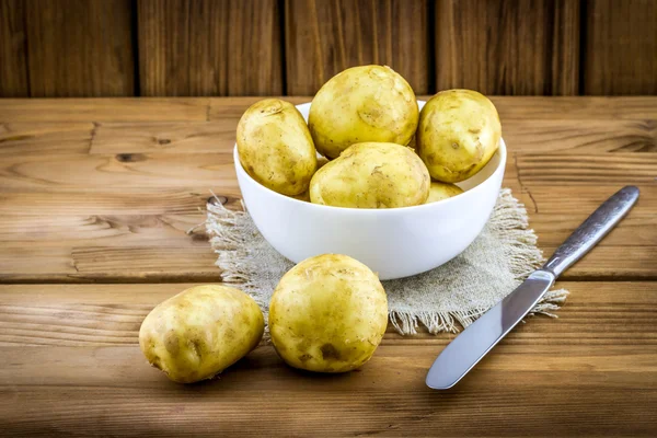 New potatoes with peel in white plate Stock Image