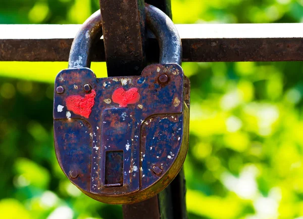 Old closed padlock with painted hearts Stock Picture