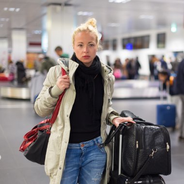 Kadın yolcunun bavulunu Havaalanı terminal içinde taşıma.
