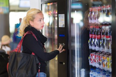 Lady using  a modern vending machine clipart