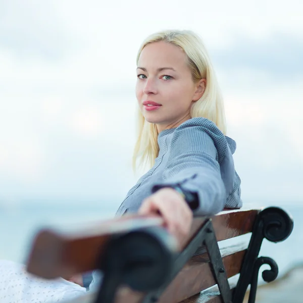 Lady sitting on a bench outdoors — Stock Photo, Image