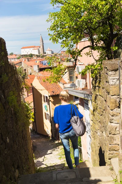 Woman walking on old cobbled street. — Stock Photo, Image