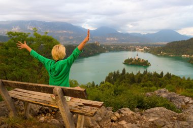 Woman enjoying panoramic view of Lake Bled, Slovenia. clipart