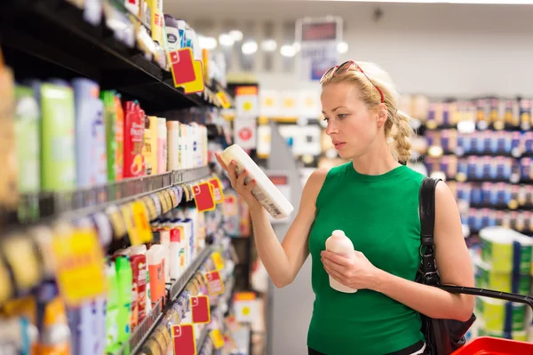 Femeia cumpără produse de igienă personală la supermarket . — Fotografie, imagine de stoc