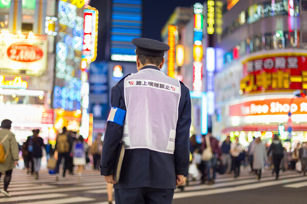 Japanese policeman standing in Shinjuku, Tokyo, Japan.