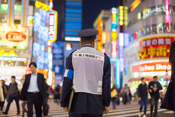 Japanese policeman standing in Shinjuku, Tokyo, Japan.