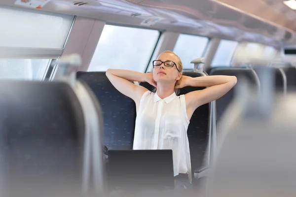 Woman streching while travelling by train. — Stock Photo, Image