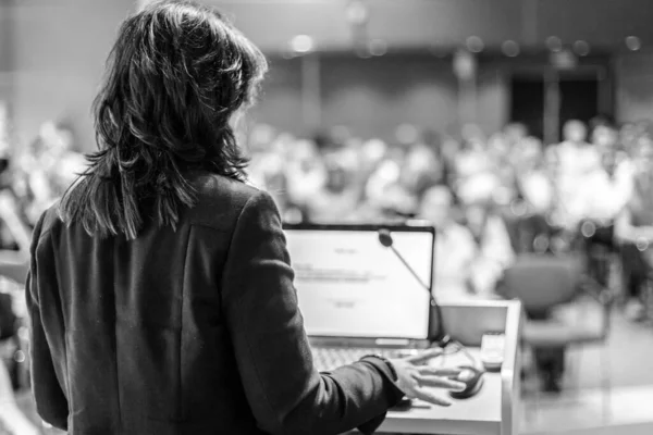 Public speaker giving talk at Business Event.