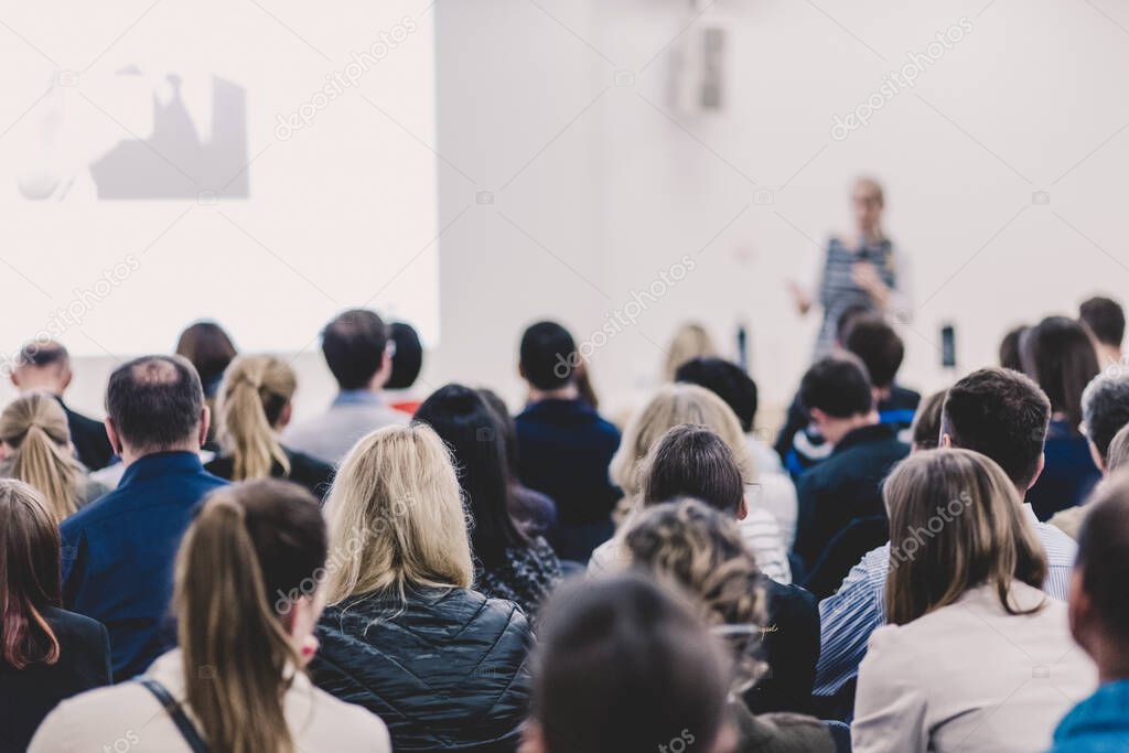 Woman giving presentation on business conference.