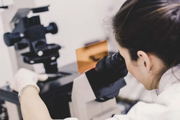 Life science researcher microscoping in genetic scientific laboratory.