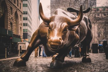 Charging Bull, landmark in Lower Manhattan, New York City, represents aggressive financial optimism and prosperity. clipart