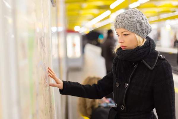 Lady looking on public transport map panel. — Stock Photo, Image