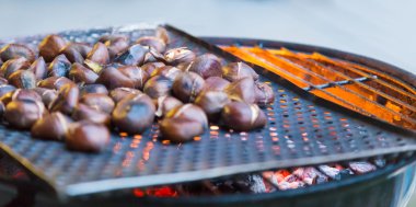 Grilling chestnuts. clipart
