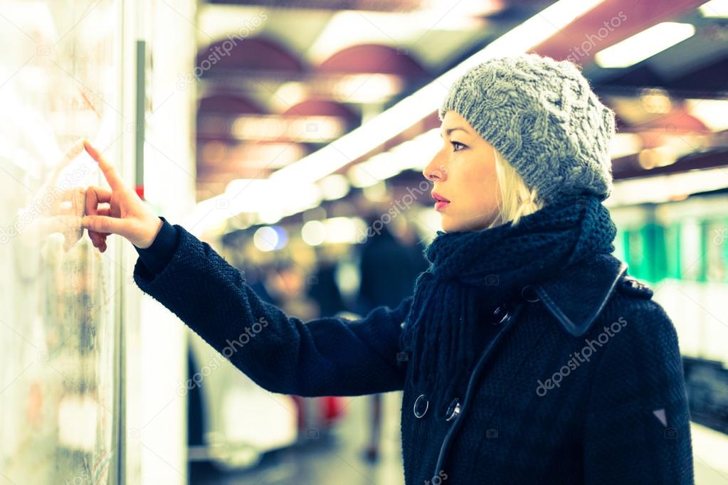 Lady looking on public transport map panel.