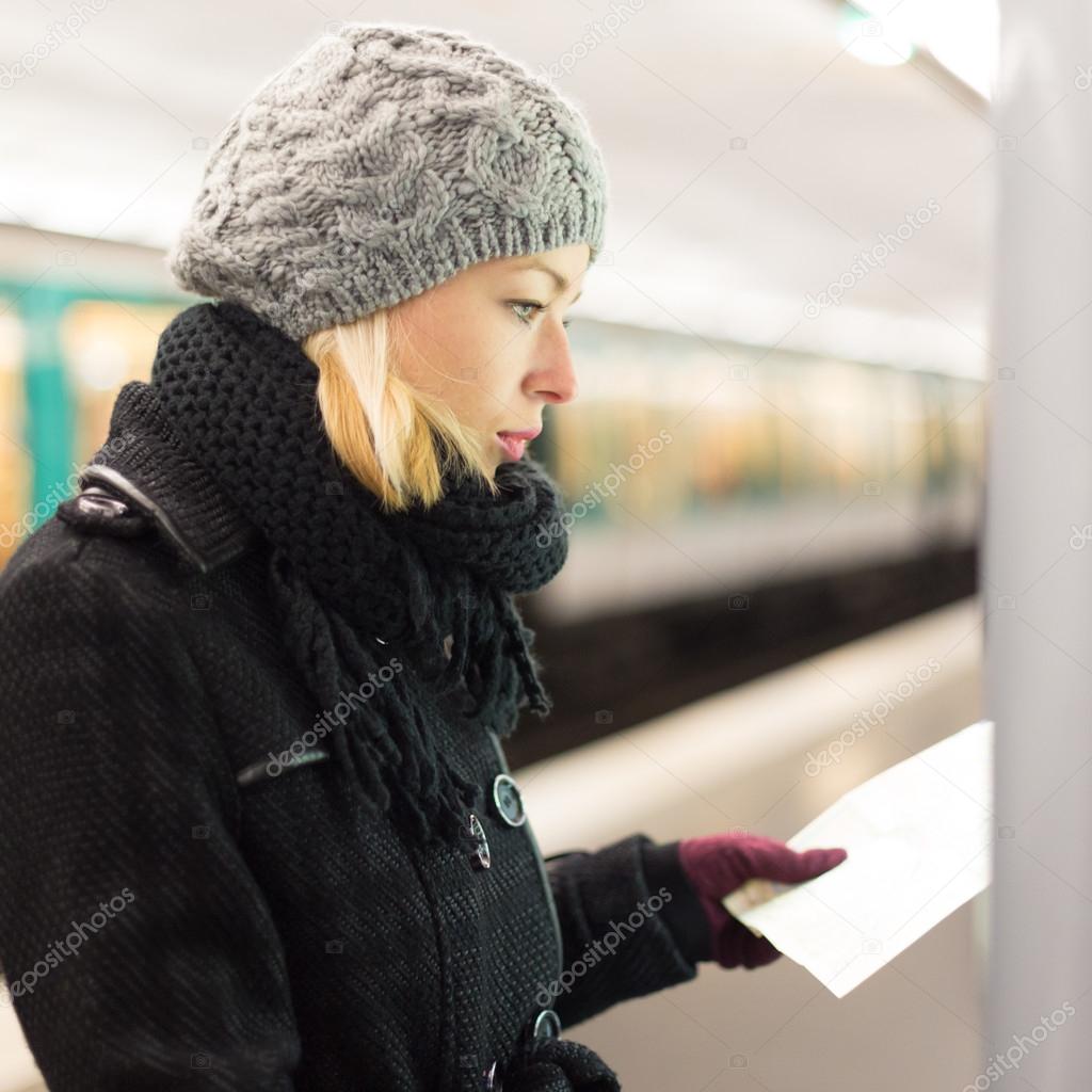 Lady looking on public transport map panel.