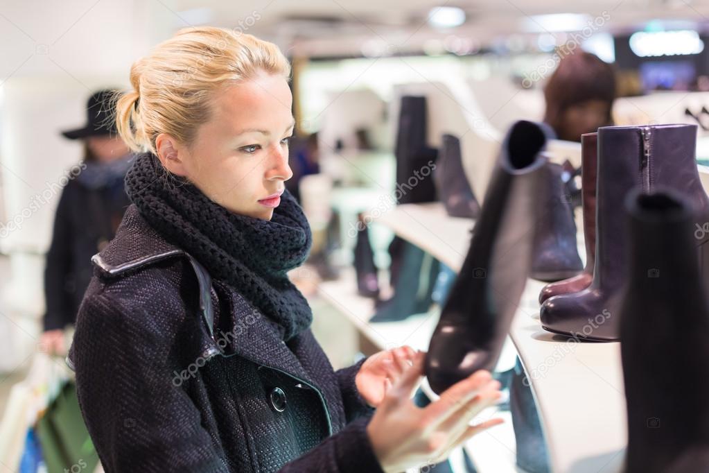 Beautiful woman shopping in shoe store.