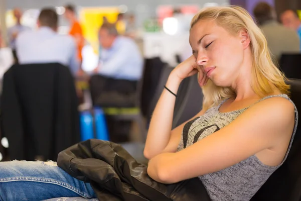 Tired female traveler waiting for departure.