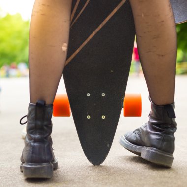 Teenage girl urban long board riding. clipart