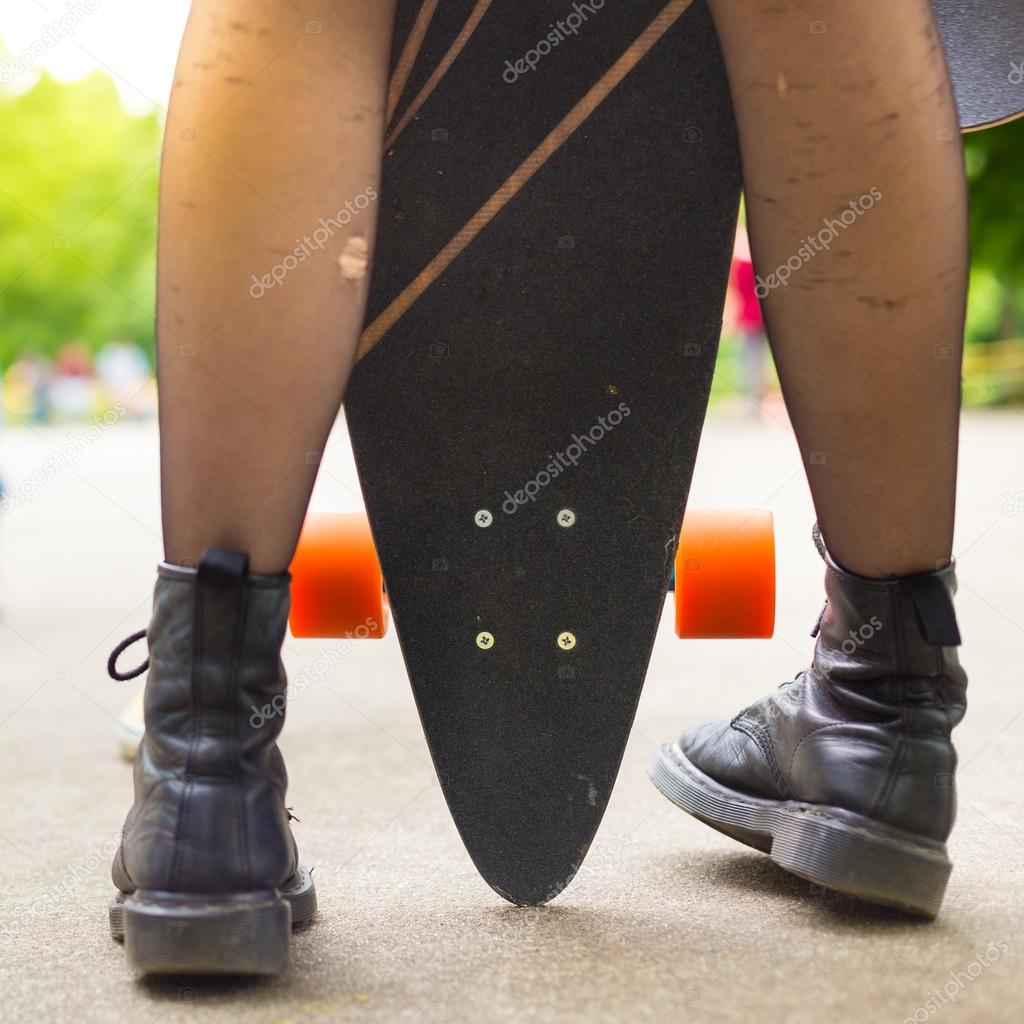 Teenage girl urban long board riding.